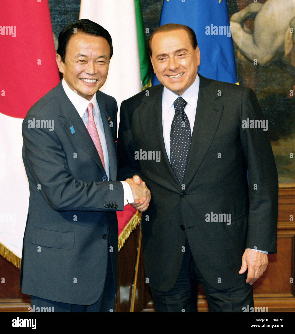 ROME, Italy - Japanese Prime Minister Taro Aso (L) and Italian Prime Minister Silvio Berlusconi (R) shake hands in Rome on July 7. (Pool photo by Kyodo News)(Kyodo) Stock Photo