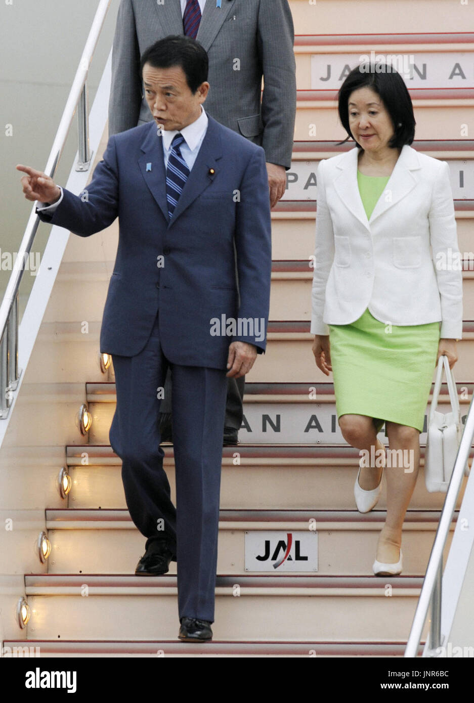 TOKYO, Japan - Japanese Prime Minister Taro Aso, accompanied by his wife Chikako, returns home at Tokyo's Haneda airport on July 11 from the summit of the Group of Eight major powers in Italy. (Kyodo) Stock Photo