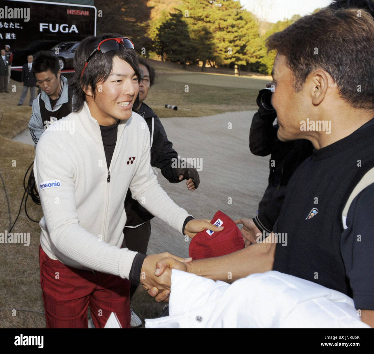 TOKYO, Japan - Ryo Ishikawa (L) congratulates Shigeki Maruyama after Maruyama won the Nippon Series JT Cup at Tokyo Yomiuri Country Club on Dec. 6, 2009. Ishikawa came 19th in the season's final tournament but became the youngest money champion in Japanese golf history. (Kyodo) Stock Photo