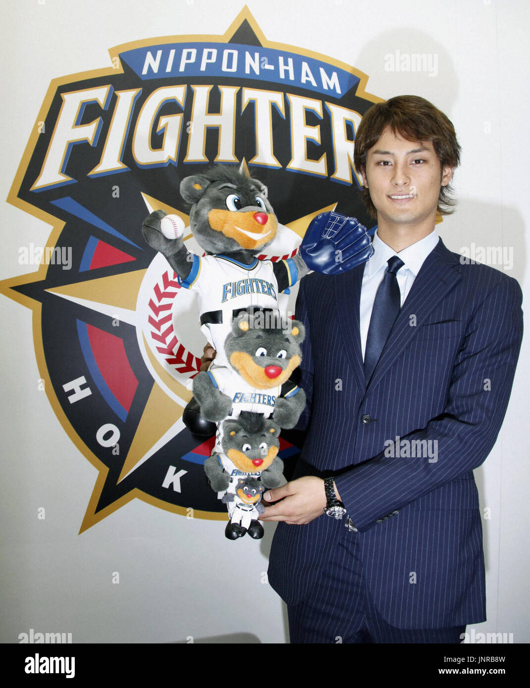 SAPPORO, Japan - Pacific League MVP Yu Darvish of the Nippon Ham Fighters  holds club mascots at its office in Sapporo on Dec. 9, 2009. The  23-year-old right-hander became the youngest player