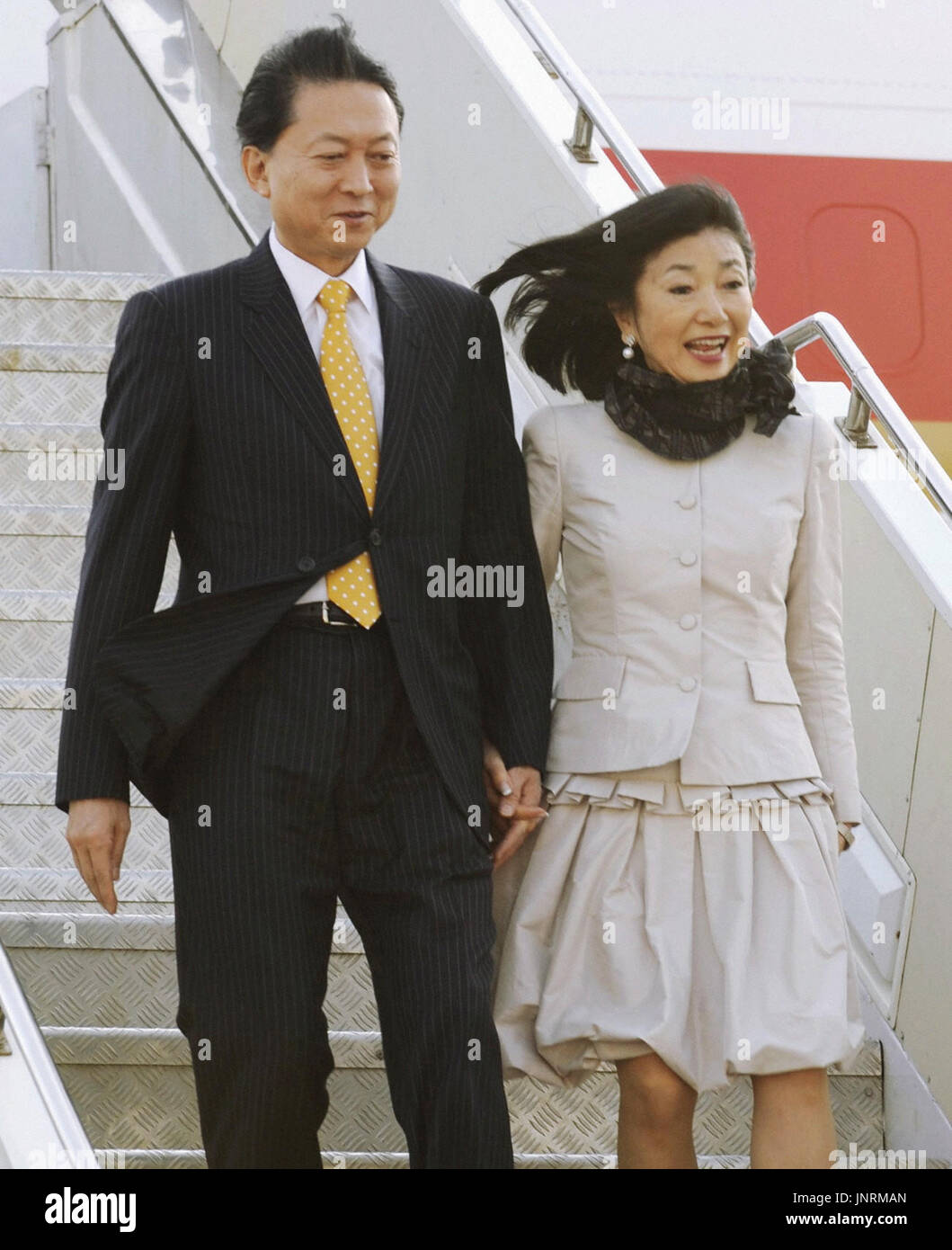 MUMBAI, India - Japanese Prime Minister Yukio Hatoyama (L) and his wife Miyuki alight from their aircraft on arriving in Mumbai on Dec. 27, 2009. Hatoyama arrived in the western Indian city the same day on the first leg of a three-day visit to India. (Kyodo) Stock Photo