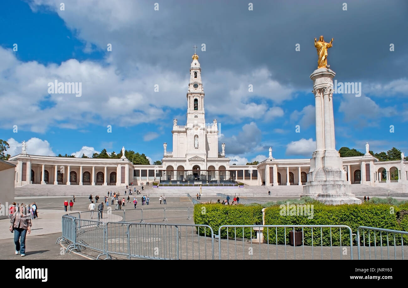 FATIMA, PORTUGAL - April 30, 2012: The facade of Sanctuary of Our Lady of Fatima with the golden statue of Jesus Christ on the foreground, on April 30 Stock Photo
