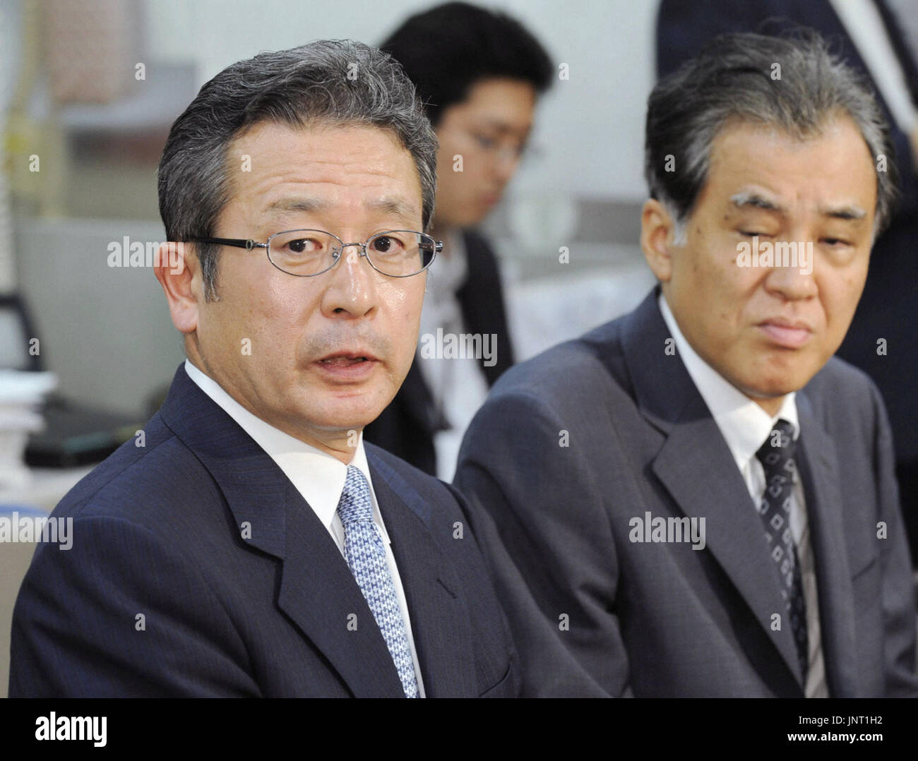 TOKYO, Japan - Go Egami (L), new president of the Incubator Bank of Japan,  shows a stern look during a news conference at the Bank of Japan's  headquarters in Tokyo on July