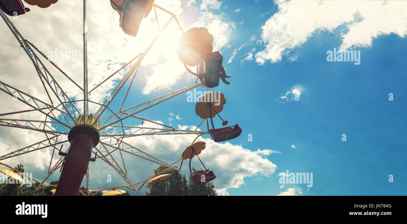 amusement park carousel against blue sky with copy space Stock Photo