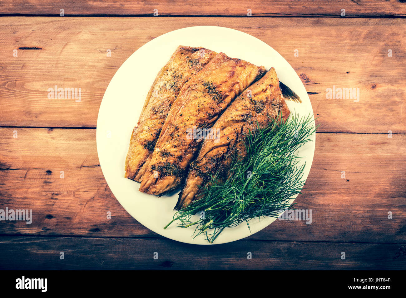 smoked mackerel fish fillet with herbs. top view Stock Photo