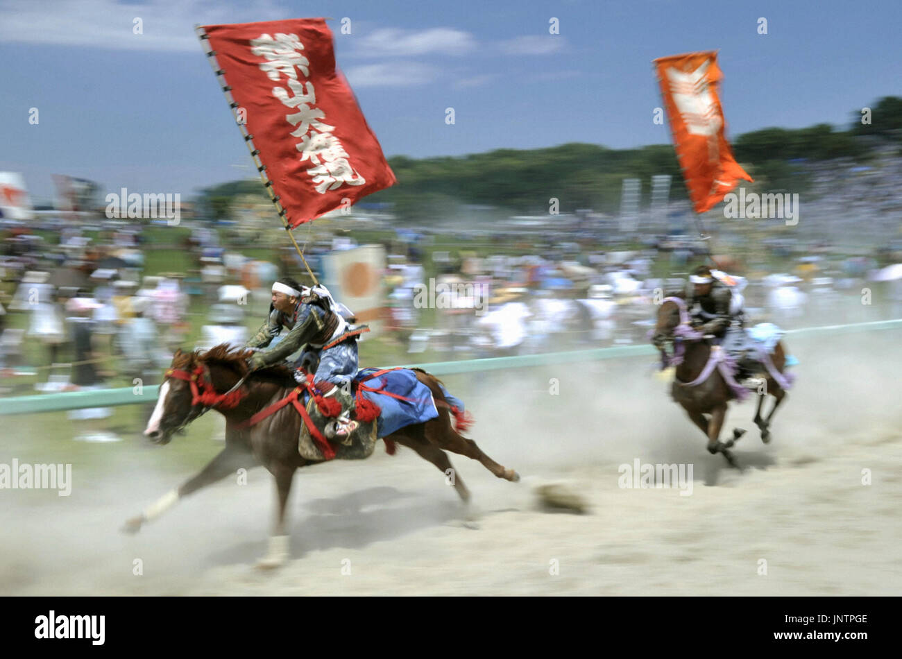 Samurai Parallel Races MINAMISOMA, Japan - Performers wearing samurai armor on horseback run ...