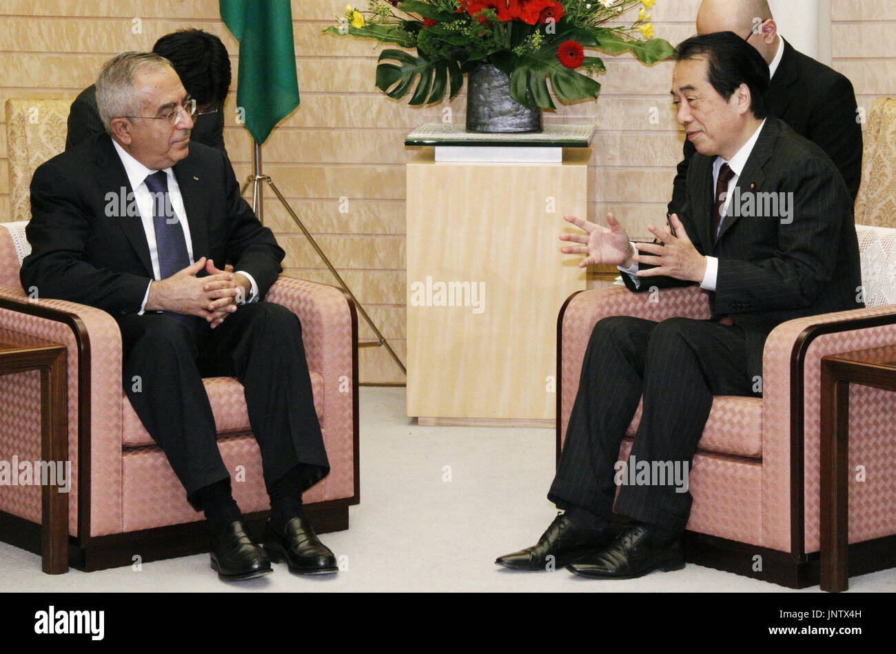 TOKYO, Japan - Japanese Prime Minister Naoto Kan (R) and Palestinian Prime Minister Salam Fayyad speak during their meeting at the premier's office in Tokyo on Nov. 24, 2010. Kan urged Fayyad to resume peace negotiations with Israel, as direct peace talks between the two sides remain stalled because of Israeli settlement on the West Bank. (Kyodo) Stock Photo