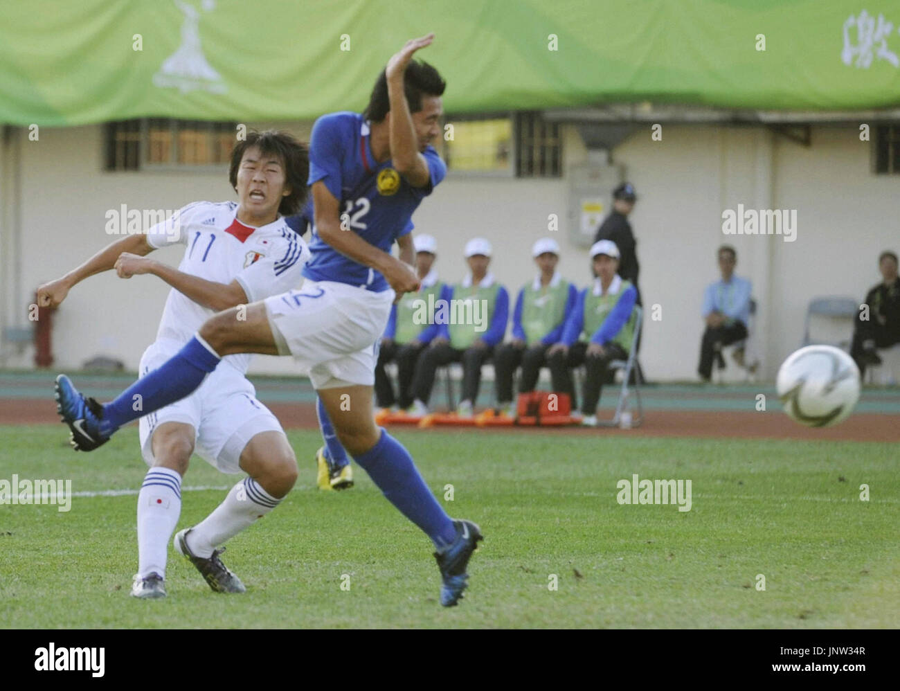 GUANGZHOU, China Japan's Kensuke Nagai (L) scores his side's first