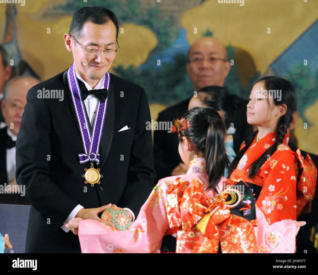 KYOTO, Japan - Shinya Yamanaka, a Kyoto University professor known for developing technologies to generate induced pluripotent stem cells, or iPS cells, receives a thread ball as a memento at the award ceremony in Kyoto on Nov. 10, 2010, for the 2010 Kyoto Prize, an international prize presented by the Inamori Foundation. Yamanaka was recognized for his contributions in the field of biotechnology and medical technology. (Kyodo) Stock Photo