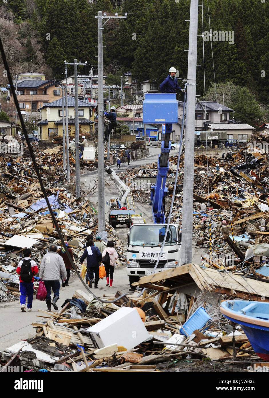 OTSUCHI, Japan - Workers repair electricity infrastructure in Otsuchi ...