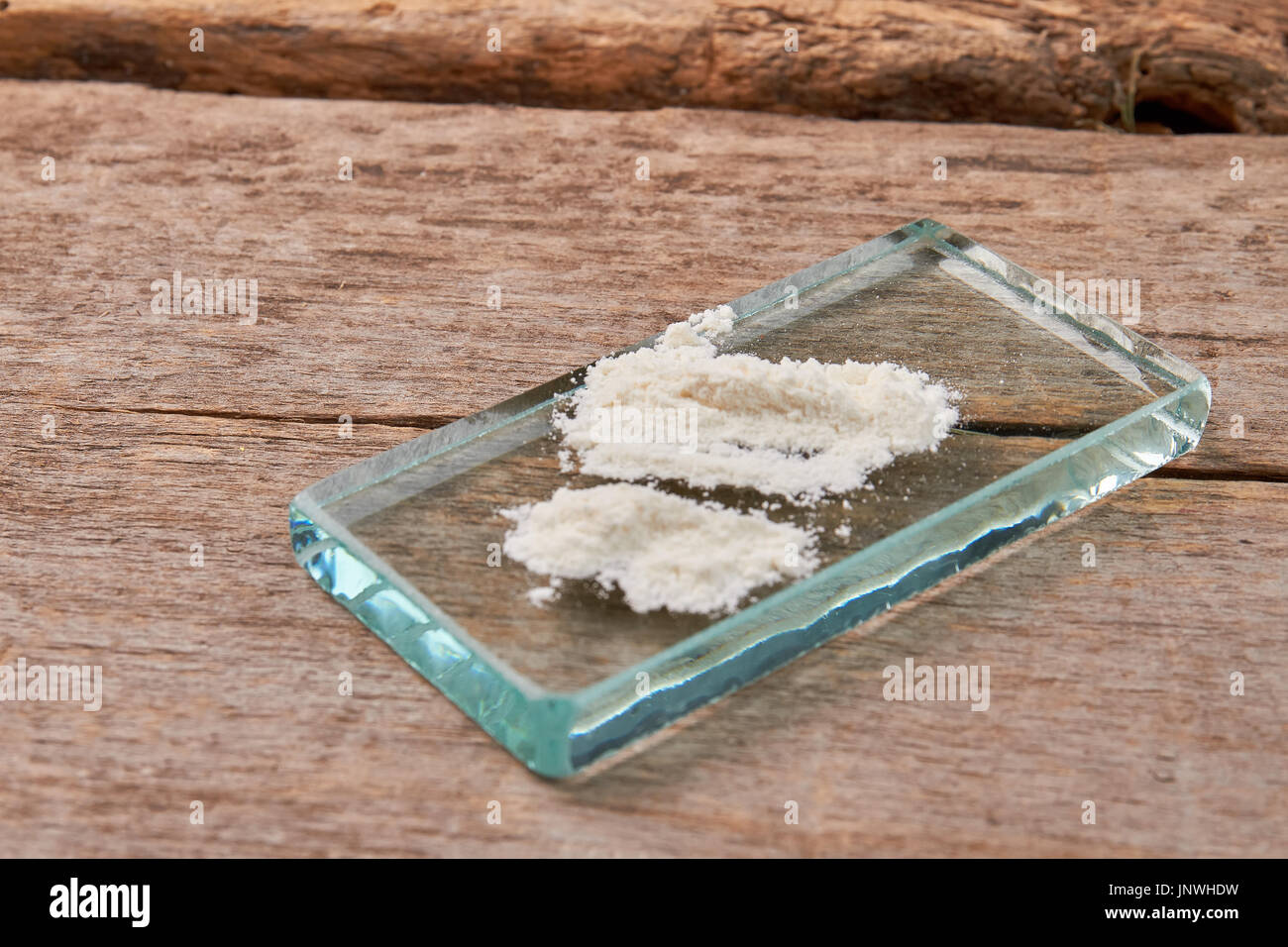 Powder of heroin, old background. Stock Photo