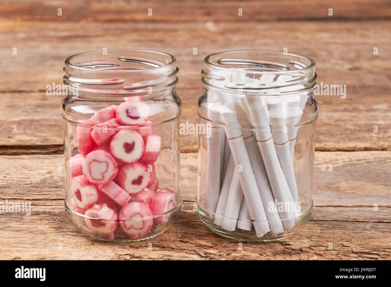 Jars with sweets and cigarettes. Stock Photo