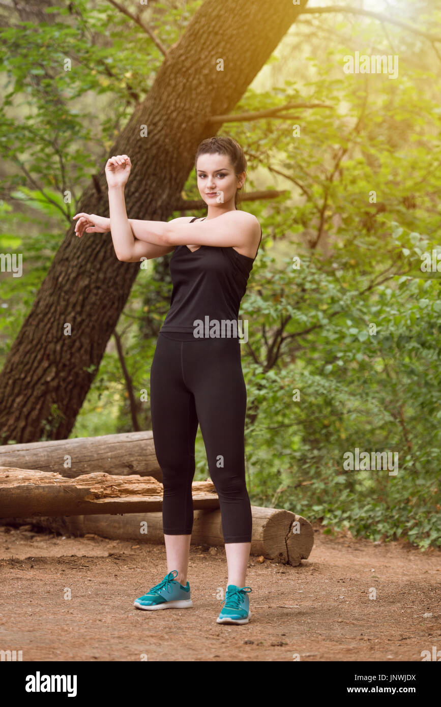 Woman stretching in woods hi-res stock photography and images - Alamy