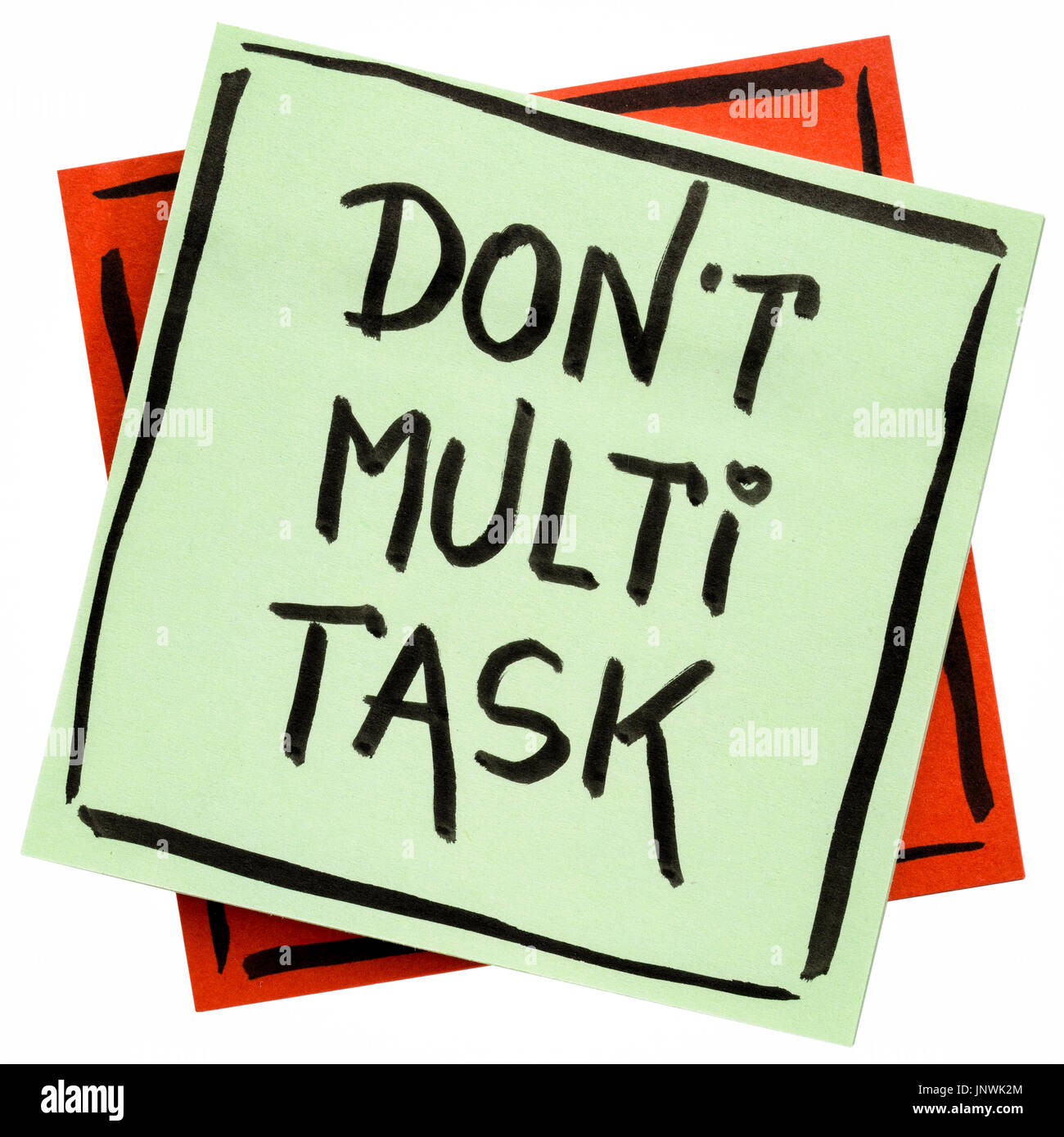 do not multitask -  efficiency advice or reminder - handwriting on an isolated sticky note Stock Photo
