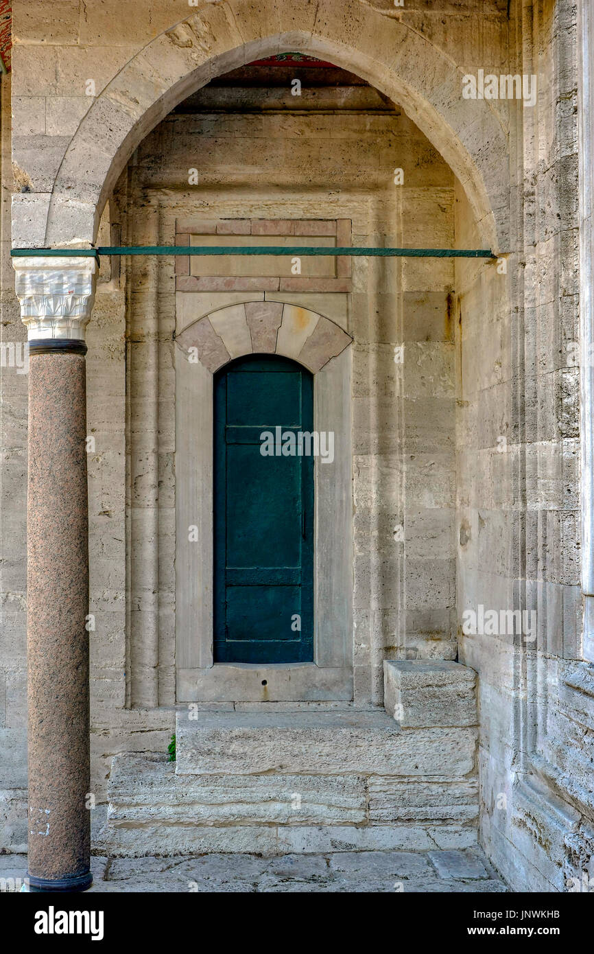 Old green mosque Ottoman wooden door in Instambul with arches and columns Stock Photo