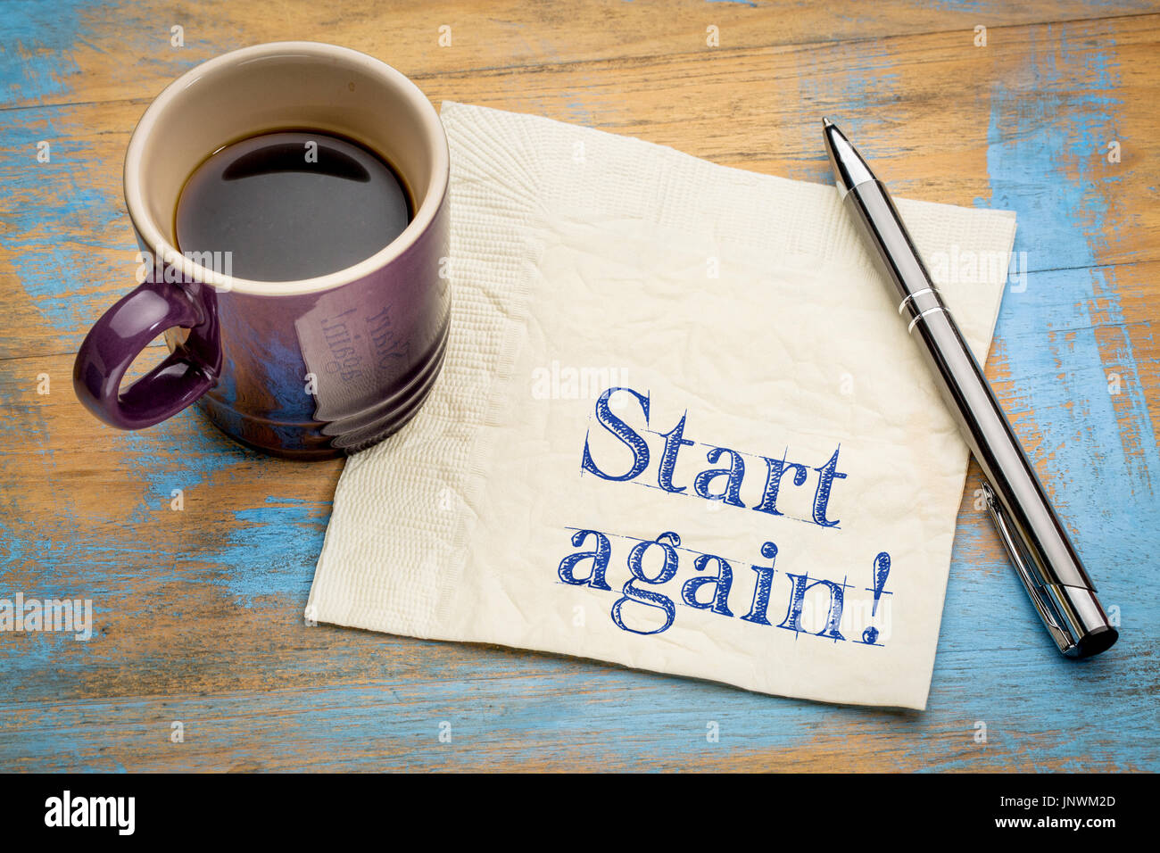 Start again motivational reminder or advice - handwriting on a napkin with a cup of espresso coffee Stock Photo