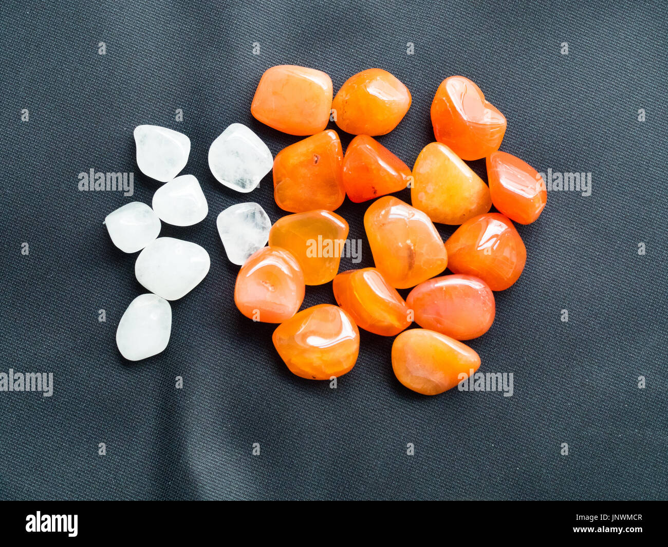Tumbled milky Quartz and carnelian stones for crystal therapy treatments and reiki Stock Photo