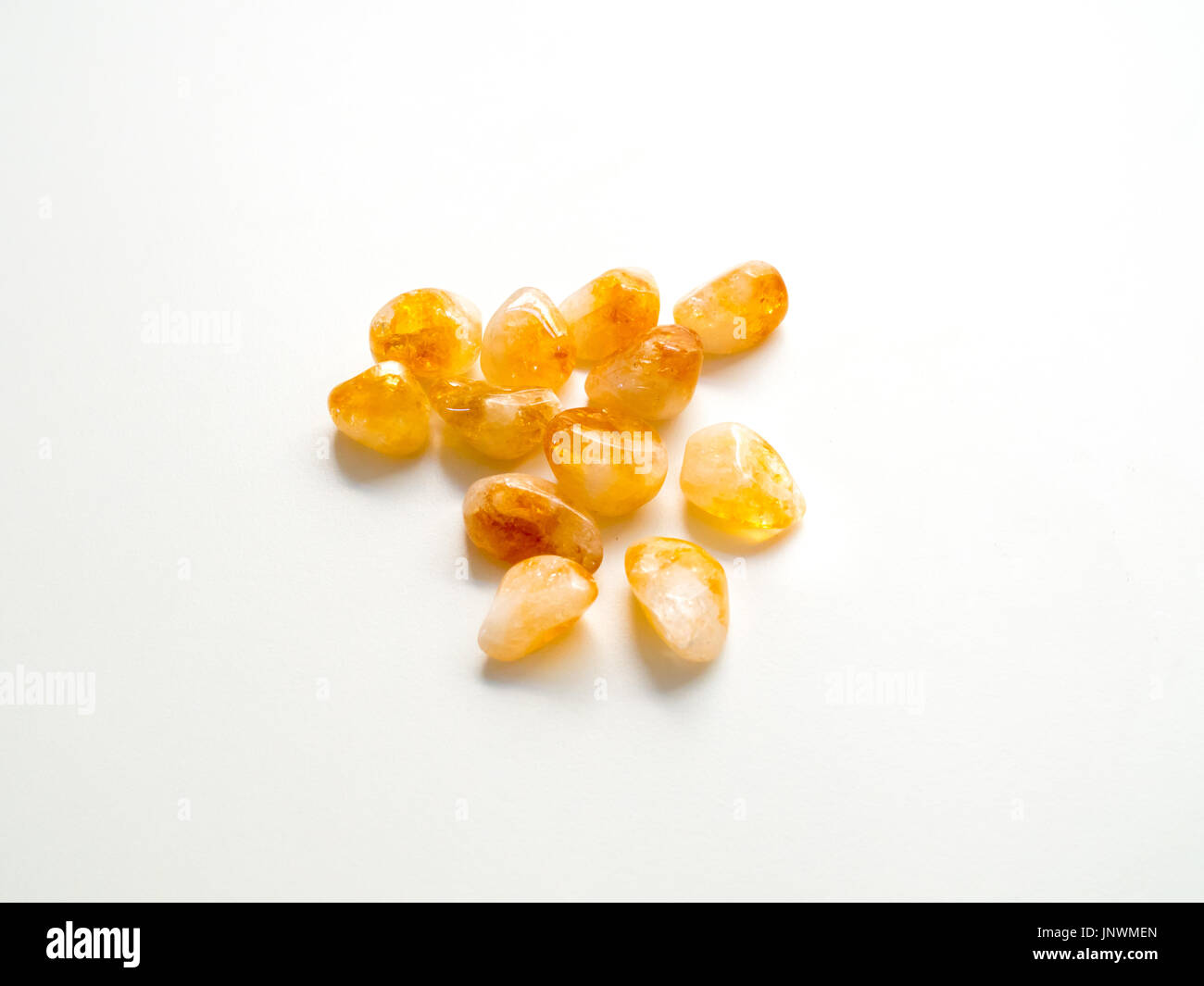 Tumbled Citrine Quartz stones close up from top for crystal therapy treatments and reiki Stock Photo