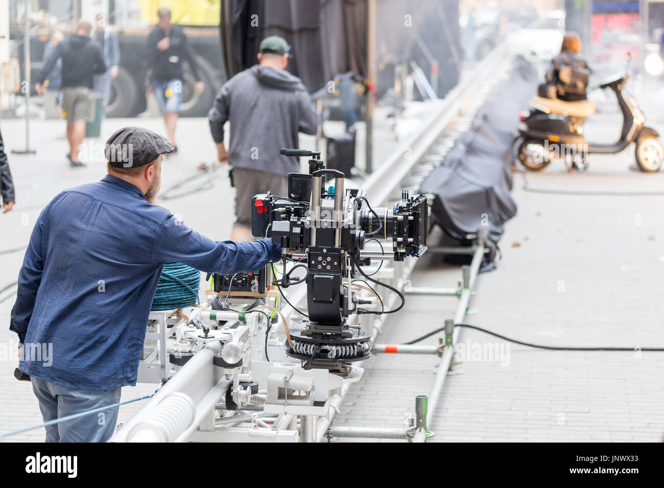 A cameraman looking to the display of big professional video camera ...