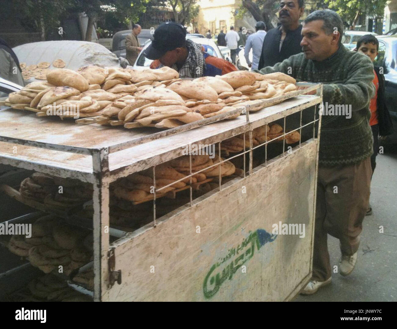 CAIRO, Egypt Men transport bread from a factory to a shop in Cairo on