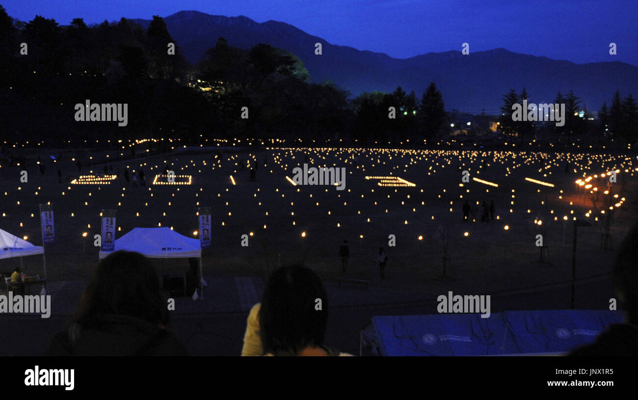 Blue Power Inawashiro INAWASHIRO, Japan - Candles and torches are lit to depict numbers ...