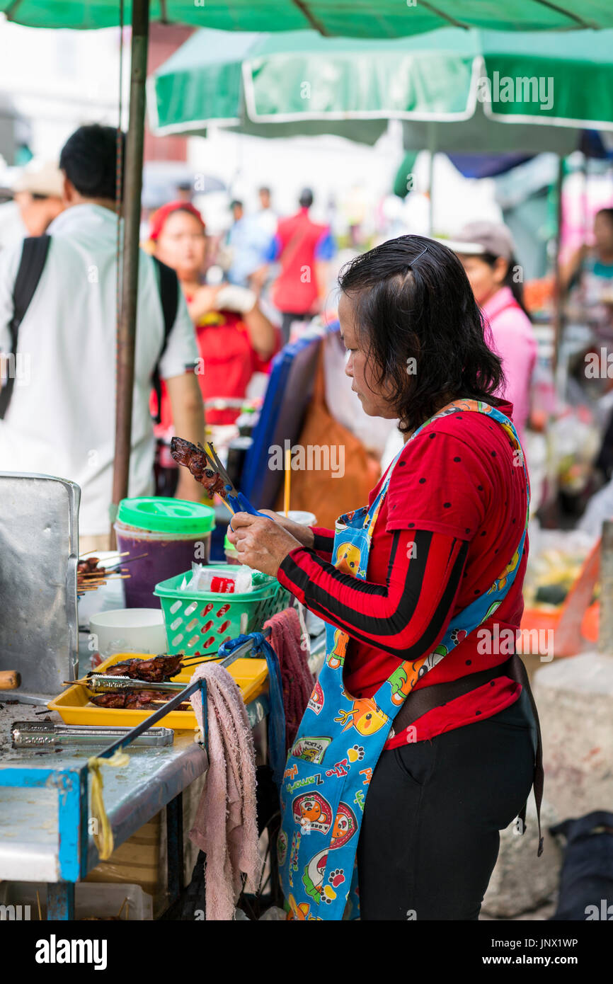 Bangkok, Thailand - February 17, 2015: woman selling cooked food from stand in the street Rattanakosin, Bangkok Old City Stock Photo