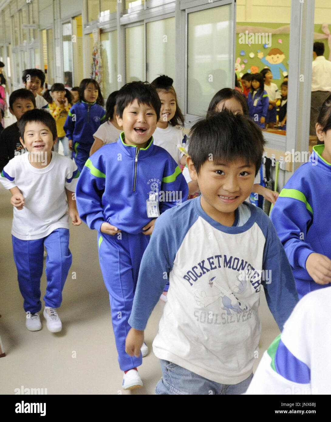 OTSUCHI, Japan - Children walk in a corridor of a temporary school ...