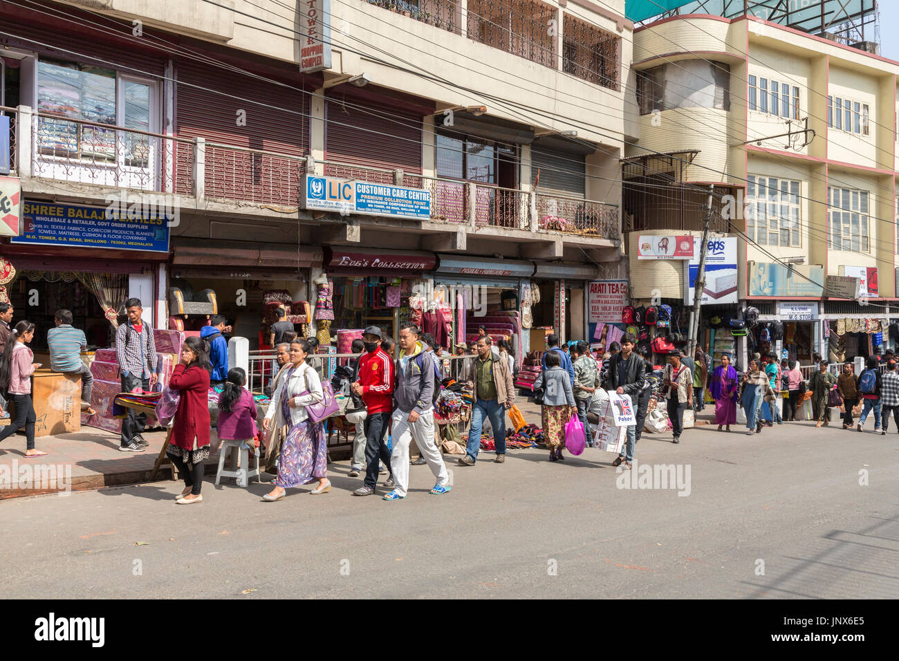 People walking past shops in street, Shillong, Meghalaya, India Stock Photo