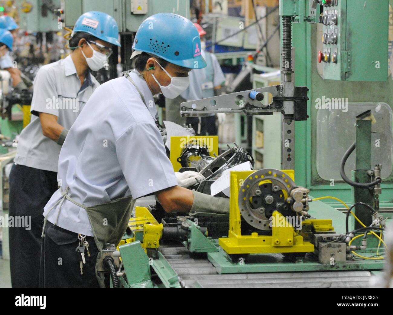 LAEM CHABANG, Thailand - Employees work at a plant of Japanese automaker Mitsubishi Motors Corp. in Laem Chabang, eastern Thailand, on Nov. 14, 2011. The plant resumed operations the same day after about a month of suspension due to supply chain disruption caused by the flooding in Thailand. (Kyodo) Stock Photo