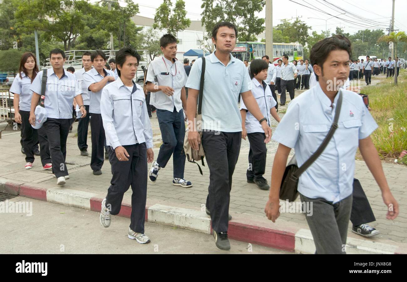 LAEM CHABANG, Thailand - Workers head to a plant of Japanese automaker Mitsubishi Motors Corp. in Laem Chabang, eastern Thailand, on Nov. 14, 2011. The plant resumed operations the same day after about a month of suspension due to supply chain disruption caused by the flooding in Thailand. (Kyodo) Stock Photo