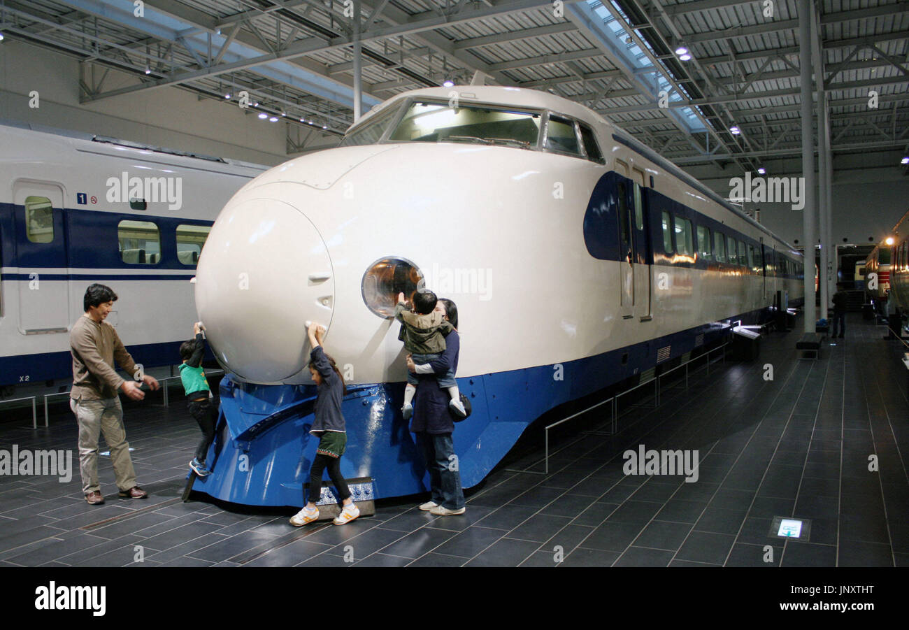 TOKYO, Japan - Members of a family have fun around a 0