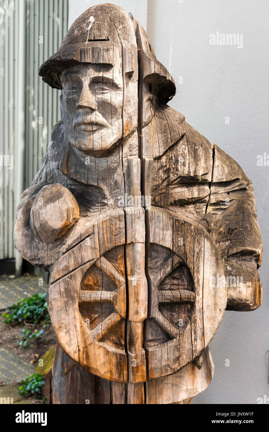 Wood Carving of Mariner with Ship Steering Wheel on Granville Island Market near False Creek Seawall in Vancouver British Columbia Canada Stock Photo