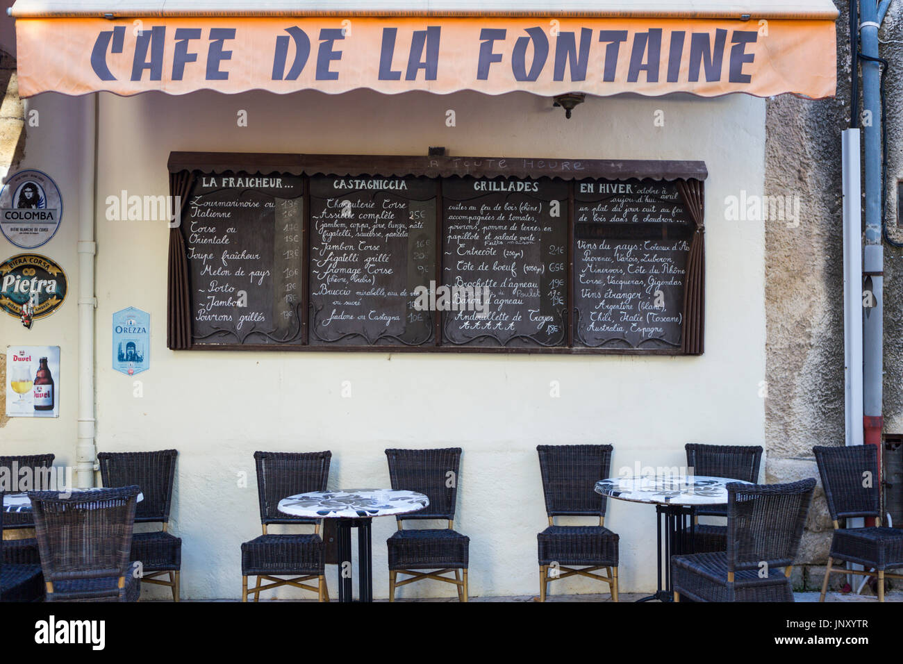 Lourmarin, Luberon, Provence, France - October 9, 2015: Tables, chairs, menu boards of the Cafe de la Fontaine, Lourmarin, Luberon, Provence, France. Stock Photo