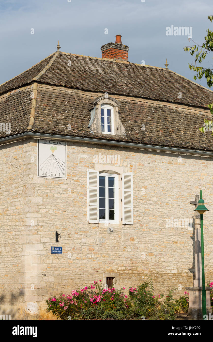 Puligny-Montrachet, Burgundy, France - October 11, 2015: Old sundial on house in the Place de Johannisberg in Puligny-Montrachet near Beaune, Burgundy, France, on the wine route in Burgundy. Stock Photo