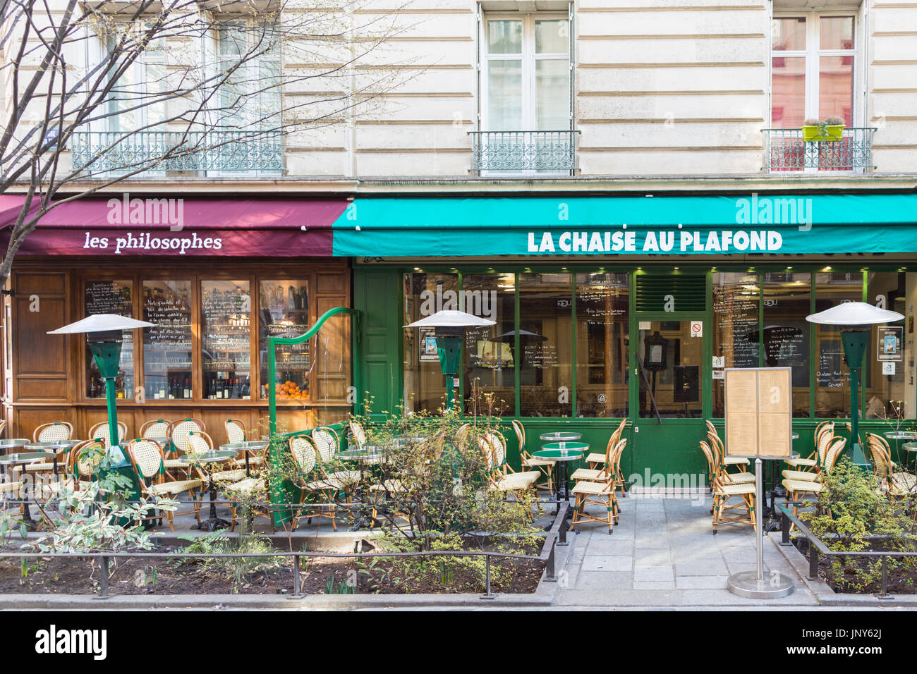 Paris, France - February 29, 2016: Cafes with chairs and tables outside in the Marais, Paris. Stock Photo