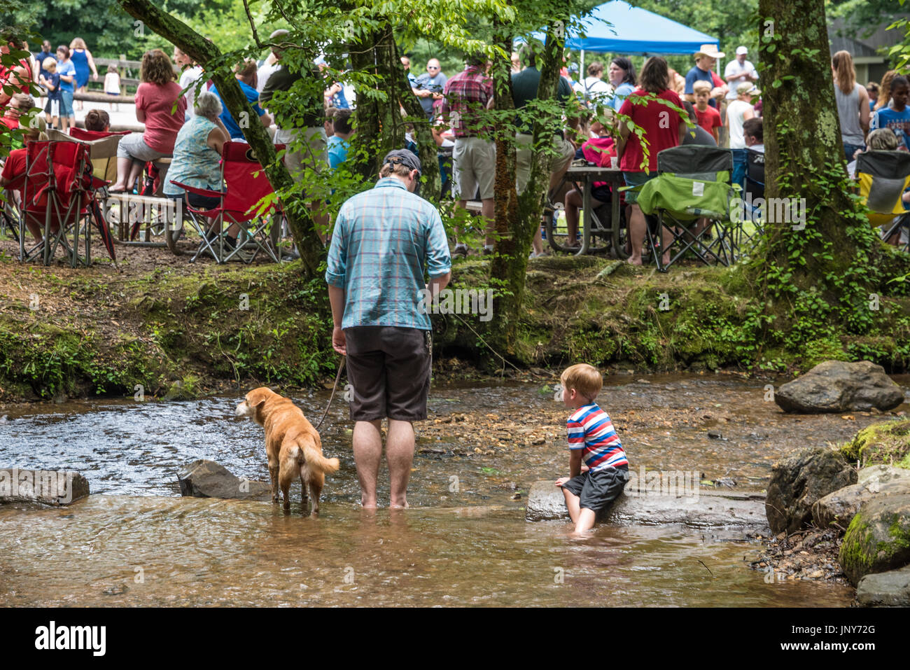 Enjoying a mountain stream at Vogel State Park while a crowd of vacationing campers gather for the annual 4th of July Family Games celebration. (USA) Stock Photo