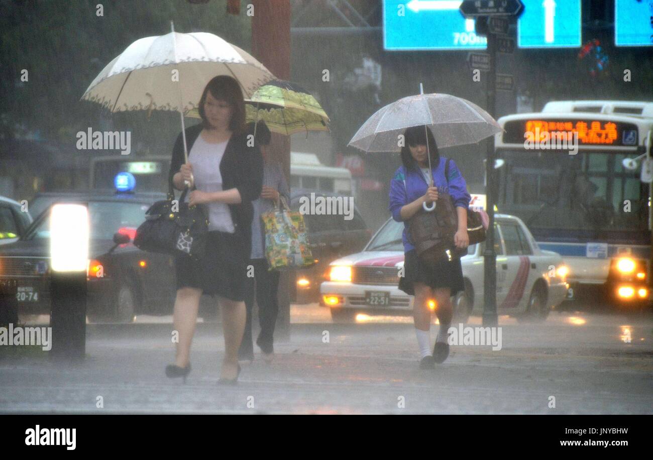MIYAZAKI, Japan People cross an intersection in rain in Miyazaki, Miyazaki Prefecture, on June