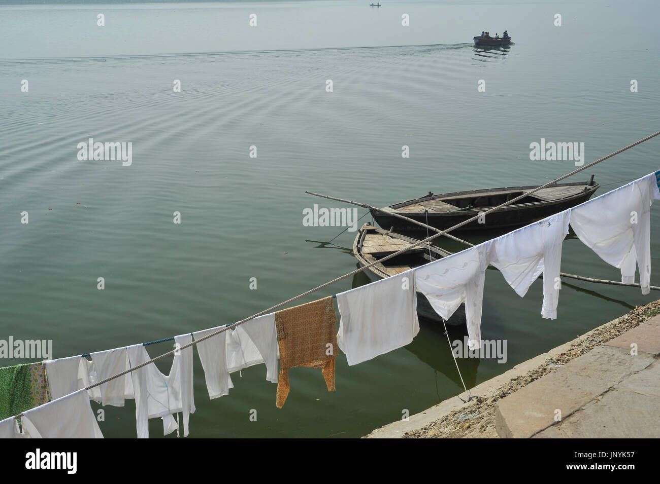 Scene of rowing boats and washing hanging by the Ganges Stock Photo