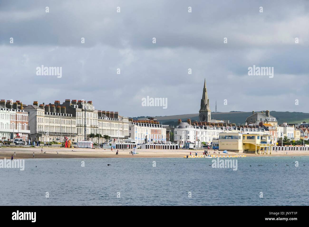 Weymouth, Dorset, UK. 31st July 2017.  UK Weather.    A view of the beach and moody sky at the seaside resort of Weymouth in Dorset on a morning of cloudy and sunny spells.  Photo Credit: Graham Hunt/Alamy Live News Stock Photo