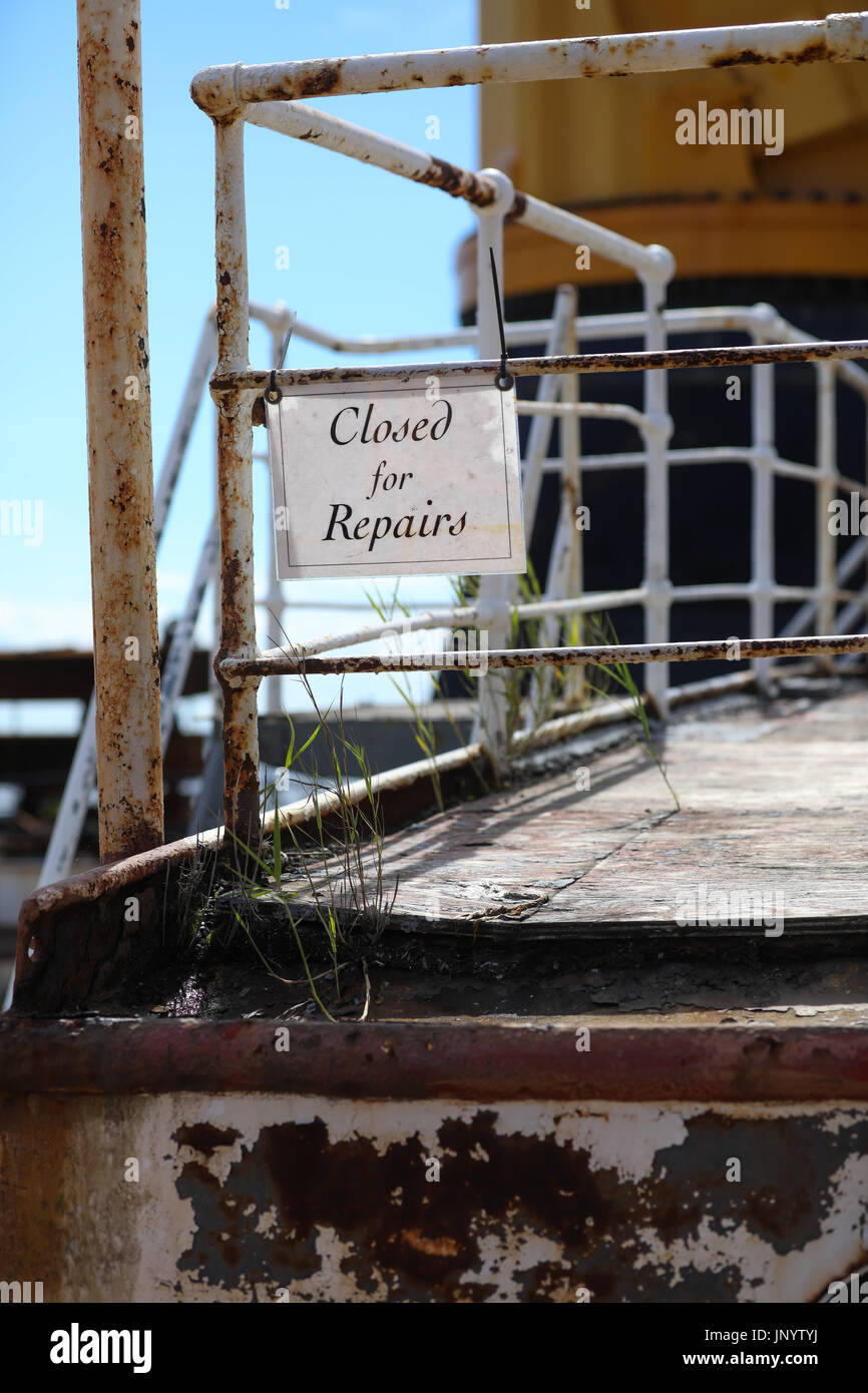 Brunsbuettel, Germany. 31st July, 2017. Grass and a sign saying 'closed for repairs' can be seen on the weathered deck of the museum ship 'Peking' (lit. Beijing) at the transport ship 'Combi Dock III' in Brunsbuettel, Germany, 31 July 2017. Before the freight sailboat returns to his former home port it is going to be renovated at the Peters shipyard in Wewelsfleth. The historic four-masted barque 'Peking' was launched at the Hamburg shipyard Blohm Voss on 21 September 1911. Photo: Christian Charisius/dpa/Alamy Live News Stock Photo