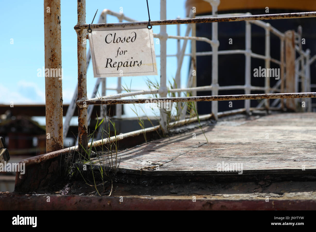 Brunsbuettel, Germany. 31st July, 2017. Grass and a sign saying 'closed for repairs' can be seen on the weathered deck of the museum ship 'Peking' (lit. Beijing) at the transport ship 'Combi Dock III' in Brunsbuettel, Germany, 31 July 2017. Before the freight sailboat returns to his former home port it is going to be renovated at the Peters shipyard in Wewelsfleth. The historic four-masted barque 'Peking' was launched at the Hamburg shipyard Blohm Voss on 21 September 1911. Photo: Christian Charisius/dpa/Alamy Live News Stock Photo