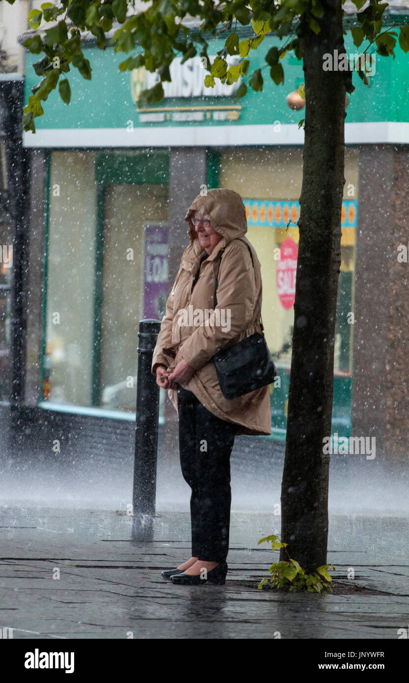 Dundee, Tayside, Scotland. 31st July, 2017. UK Weather: Torrential heavy downpours of rain soak shoppers in Dundee City Centre. The unsettled weather across Tayside caught shoppers by surprise with heavy outbursts of rain during the day. Some were prepared but others use alternative ways to shelter. Credit: Dundee Photographics /Alamy Live News Stock Photo