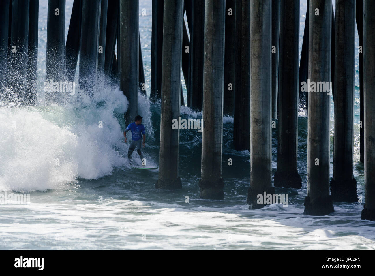 Huntington Beach, USA. 31 July, 2017. Big waves adn heavy currents forced surfers like Cooper Chapman (AUS) to crowd near the pier, leaving them little choice but to shoot the pier and avoid colliding with a concrete pylon after completing their wavesduring rounds 1 and 2 of competition at the 2017 VANS US Open of Surfing. Credit: Benjamin Ginsberg/Alamy Live News. Stock Photo