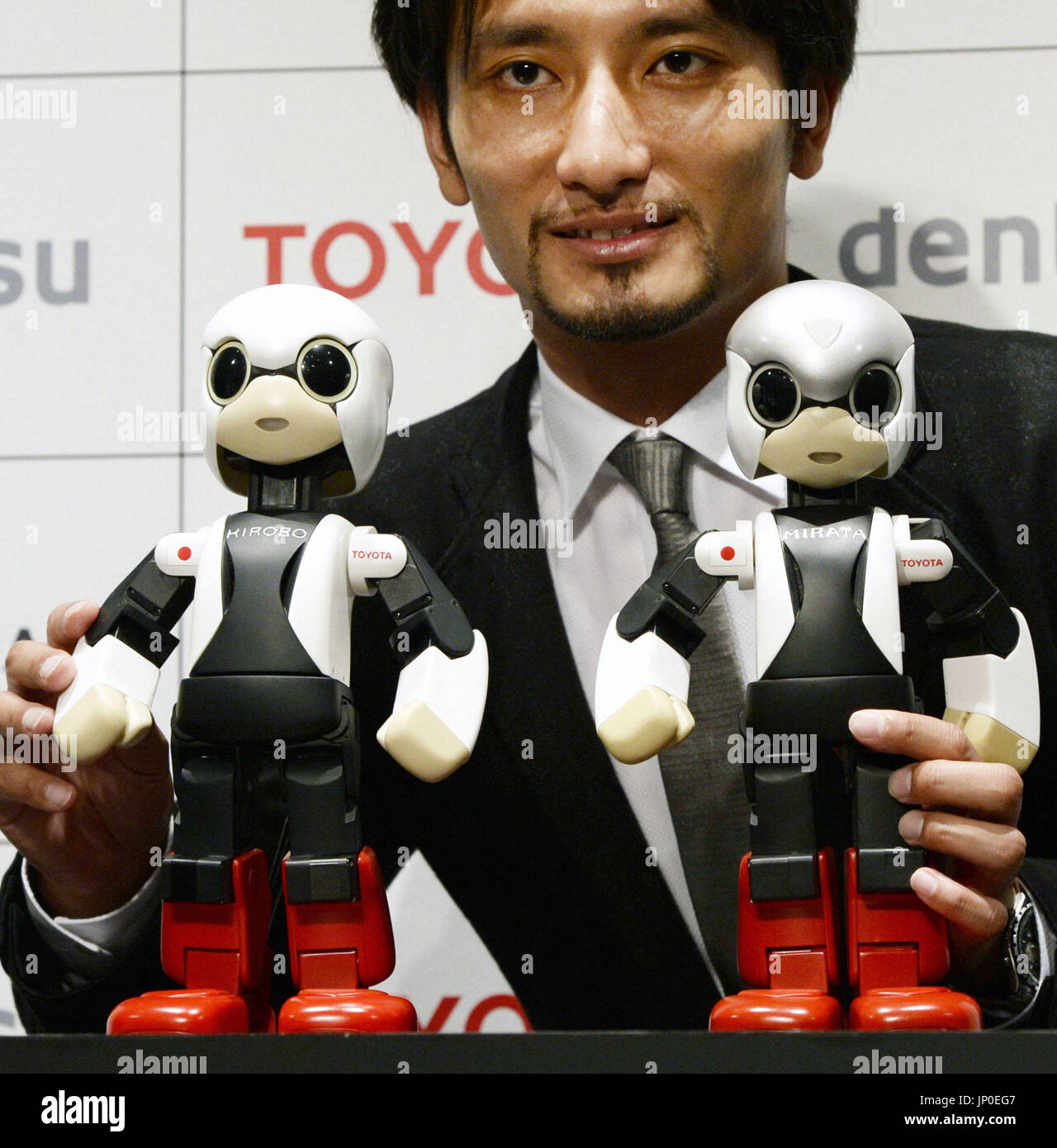 TOKYO, Japan - Tomotaka Takahashi, a roboticist at the University of Tokyo,  unveils Kirobo (L), a small talking humanoid robot, and a backup robot  called Mirata, in Tokyo on June 26, 2013.