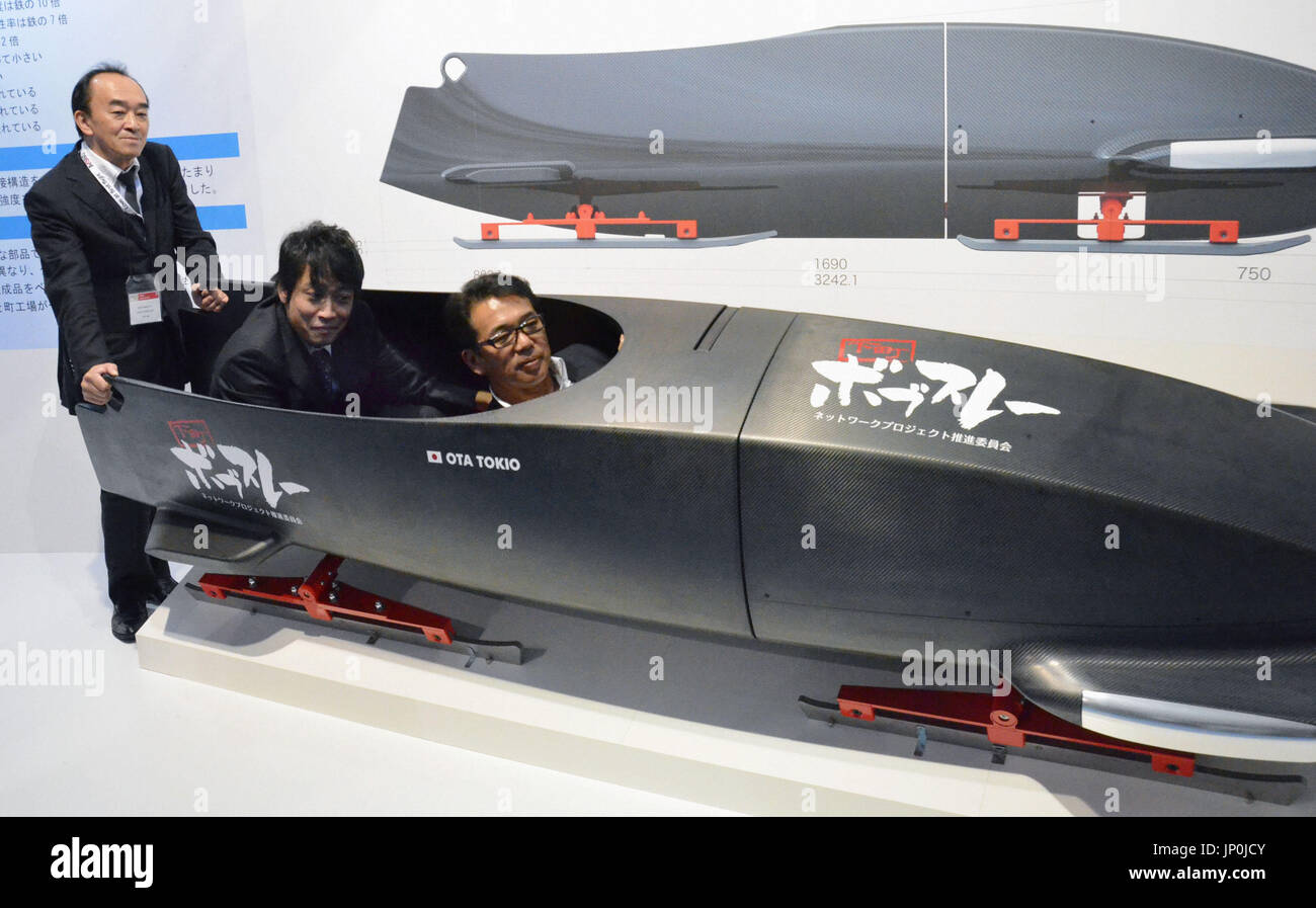 TOKYO, Japan - Junichi Hosogai (R) gets on a bobsled made by a group of ...
