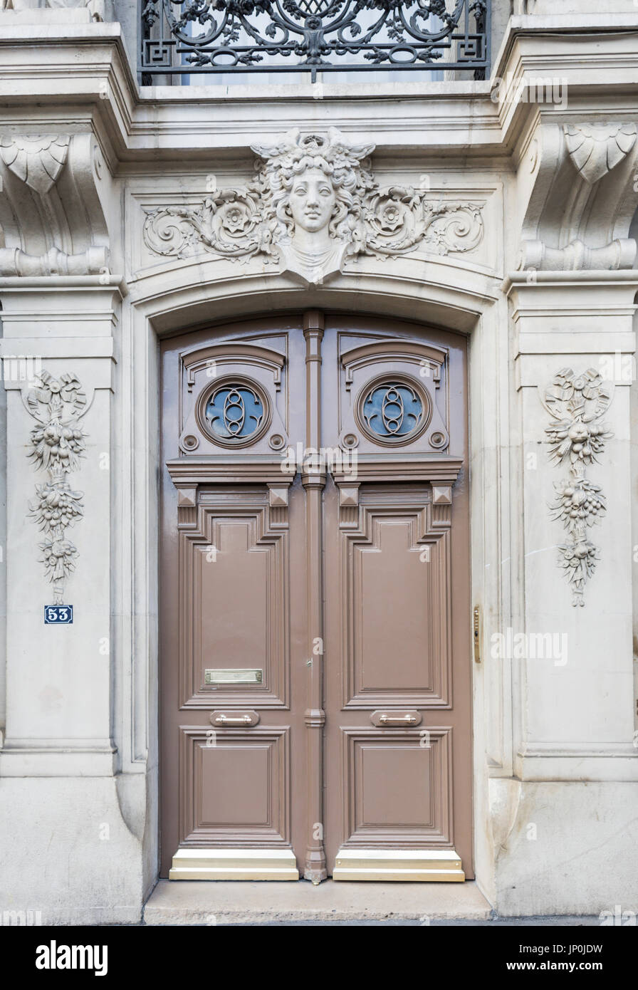 Paris, France - March 2, 2016: Elegant brown door and carved stone doorway at No 53 Quai des Grands Augustins on the left bank of the Seine opposite Ile de la Cite, Paris. Stock Photo