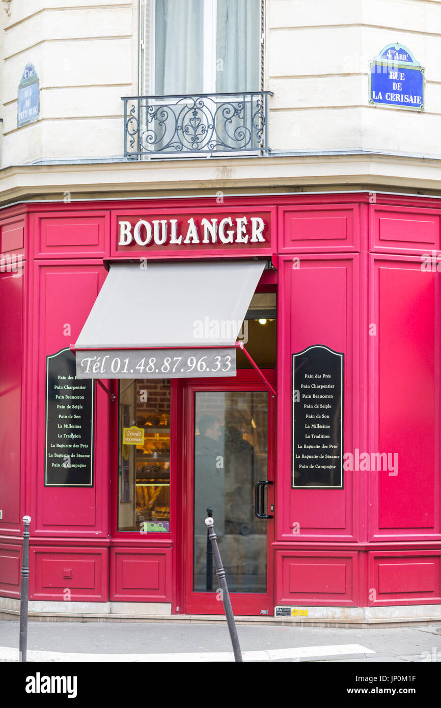 Paris, France - March 2, 2016: Red bakery and pastry shop on the corner of rue du Petit Musc and rue de la Cerisaie in the Marais, Paris. Stock Photo