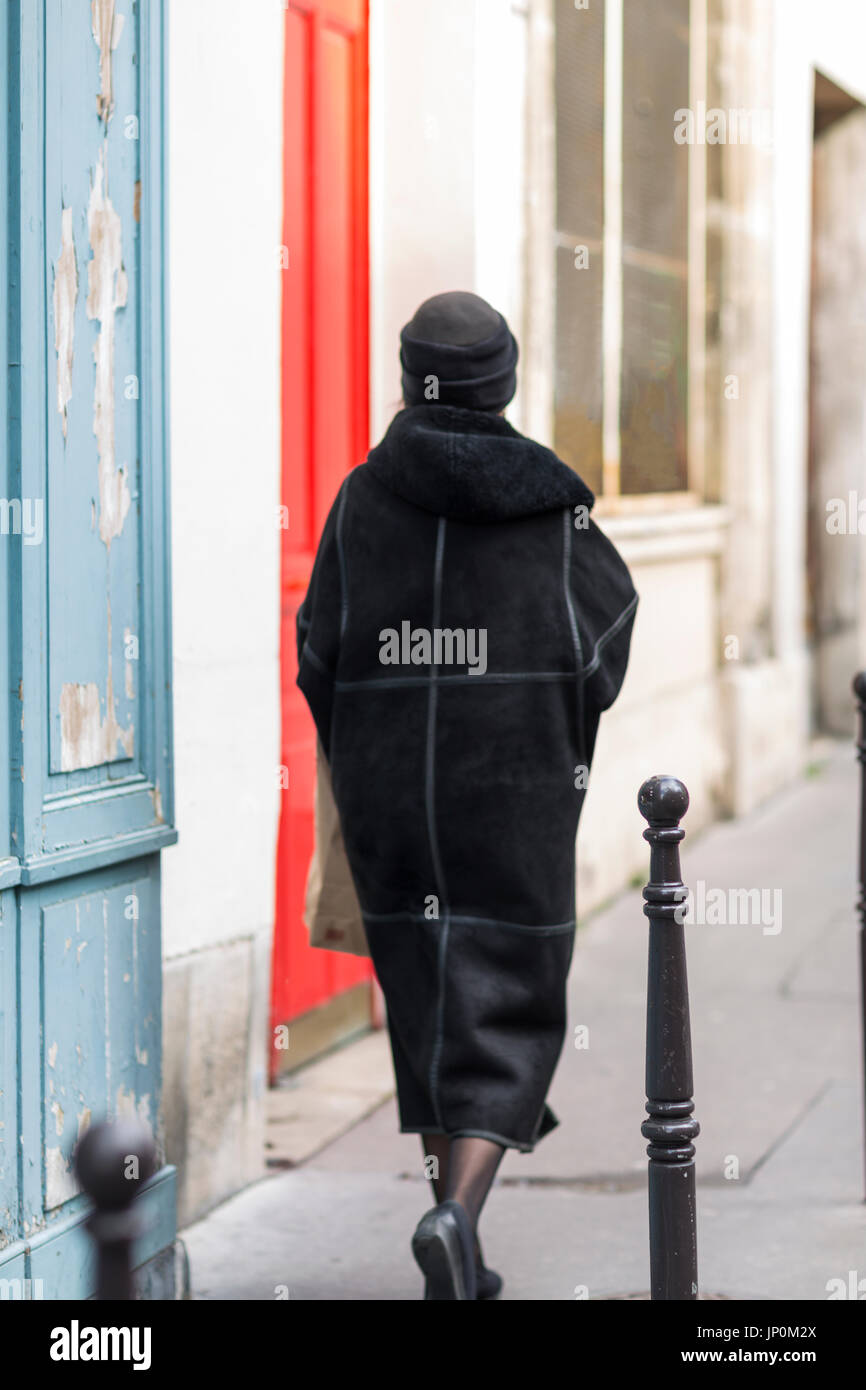 Paris, France - March 2, 2016: Elegant woman walking on rue du Petit Musc in the Marais, Paris Stock Photo