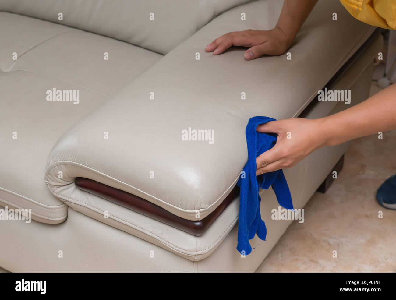 cleaning leather sofa with towel at home Stock Photo Alamy