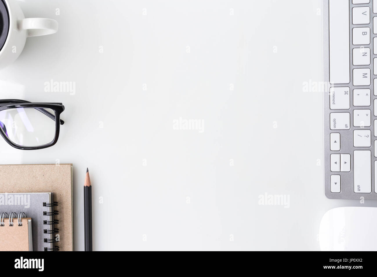 Modern white office desk top table with computer laptop, notebook and